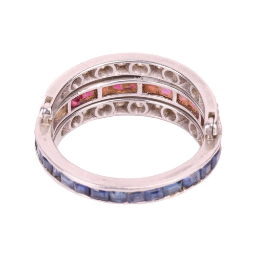 172 - A sapphire, ruby and diamond 'Day and Night' ring, one half channel set with calibré cut sapphires, ... 