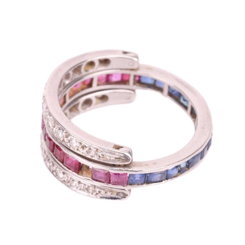 172 - A sapphire, ruby and diamond 'Day and Night' ring, one half channel set with calibré cut sapphires, ... 