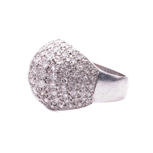 174 - A diamond-set bombé ring, pavé set with single-cut diamonds, graduating in size, in a white metal mo... 