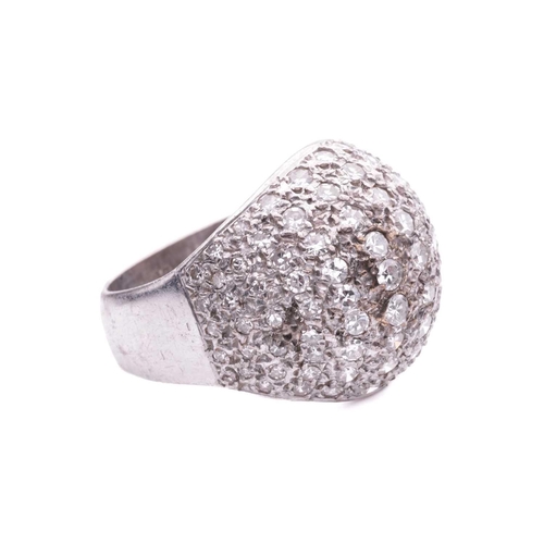 174 - A diamond-set bombé ring, pavé set with single-cut diamonds, graduating in size, in a white metal mo... 