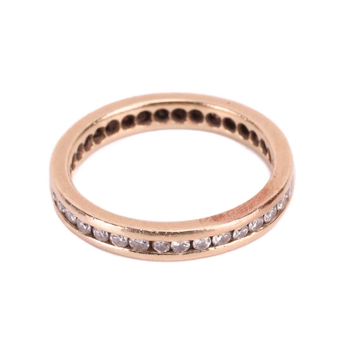 177 - A diamond eternity ring, channel-set with an array of brilliant-cut diamonds in a flat-edged band, w... 