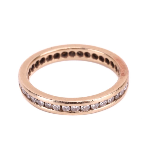 177 - A diamond eternity ring, channel-set with an array of brilliant-cut diamonds in a flat-edged band, w... 