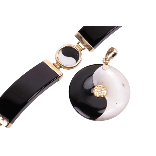 185 - A yin-yang bracelet and pendant en-suite set with mother-of-pearl and onyx; the bracelet comprising ... 