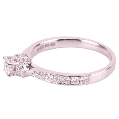 188 - A diamond solitaire ring, the central round brilliant diamond measuring approximately 3.7mm, accente... 