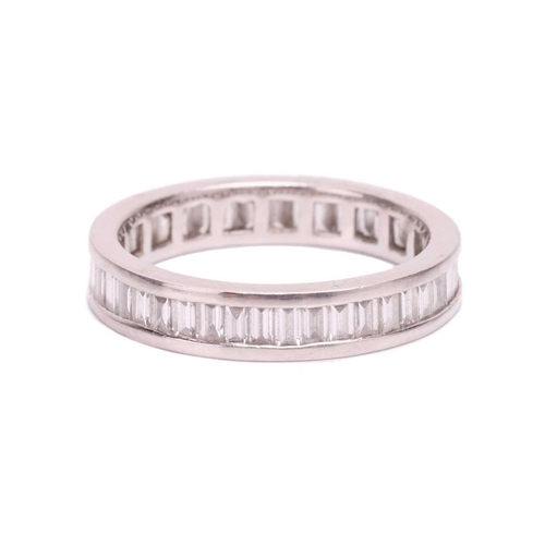 191 - A baguette cut diamond eternity ring, set with a contiuous row of baguette cut diamonds in a channel... 