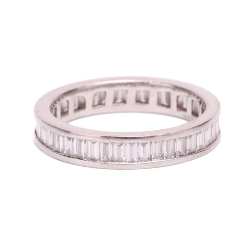 191 - A baguette cut diamond eternity ring, set with a contiuous row of baguette cut diamonds in a channel... 