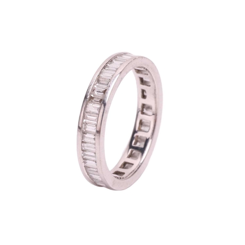 191 - A baguette cut diamond eternity ring, set with a contiuous row of baguette cut diamonds in a channel... 