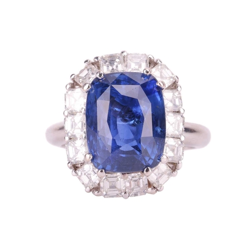 199 - A Ceylon sapphire and diamond cluster ring, featuring a cushion mixed-cut sapphire of intense blue c... 