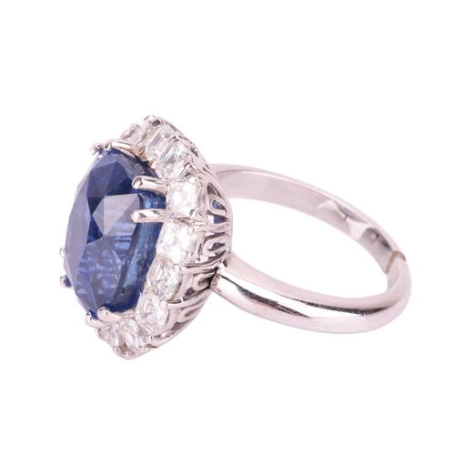 199 - A Ceylon sapphire and diamond cluster ring, featuring a cushion mixed-cut sapphire of intense blue c... 