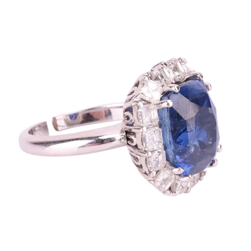 199 - A Ceylon sapphire and diamond cluster ring, featuring a cushion mixed-cut sapphire of intense blue c... 