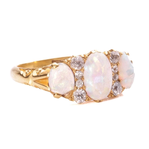 2 - An Edwardian opal and diamond half-hoop ring, comprising three graduated oval-cut precious opals wit... 