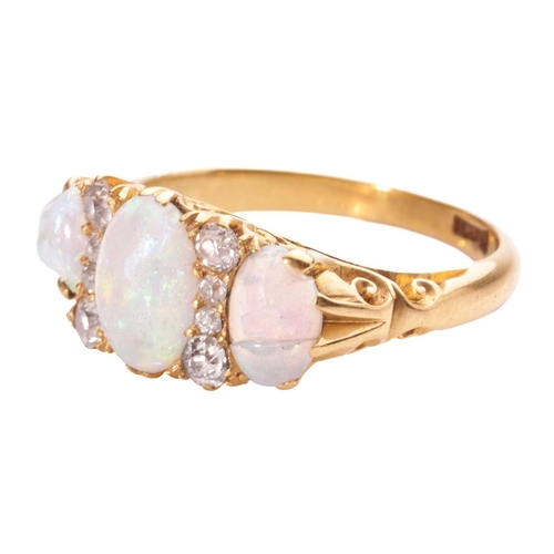 2 - An Edwardian opal and diamond half-hoop ring, comprising three graduated oval-cut precious opals wit... 