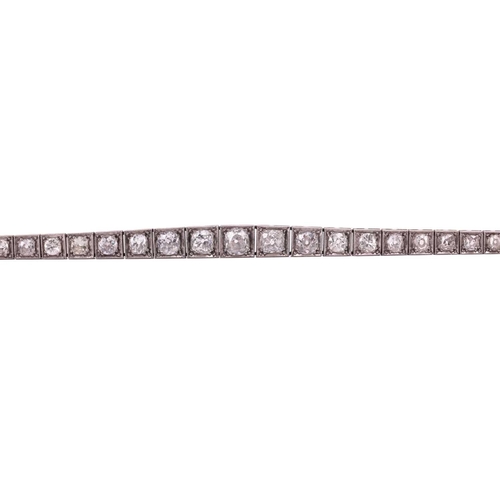 200 - An Art Deco diamond line bracelet circa 1920s, featuring a single row of cushion shape old cut diamo... 