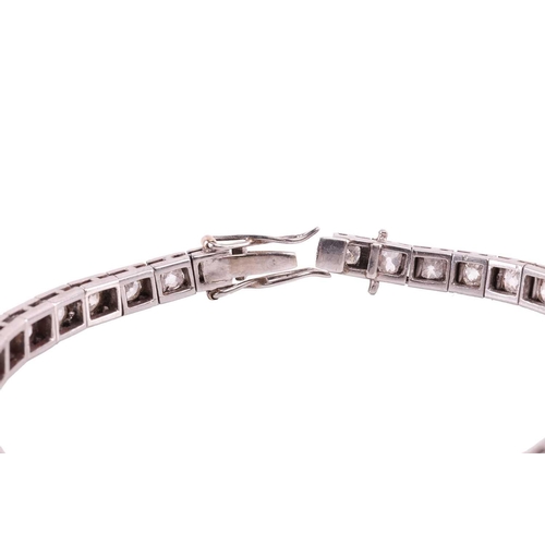 200 - An Art Deco diamond line bracelet circa 1920s, featuring a single row of cushion shape old cut diamo... 