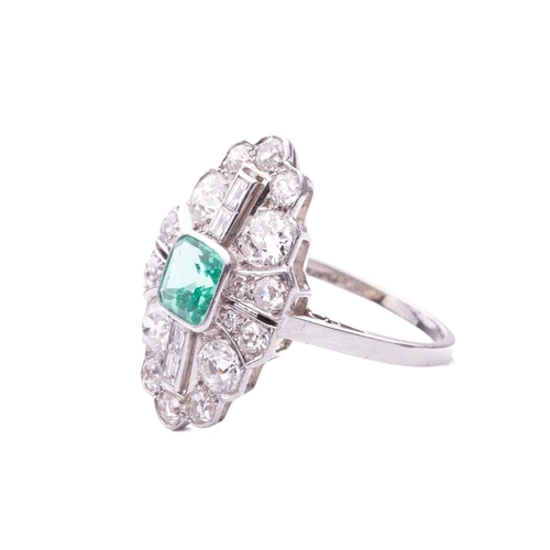 202 - An Art Deco emerald and diamond plaque ring, slightly raised at the centre with a square step-cut em... 