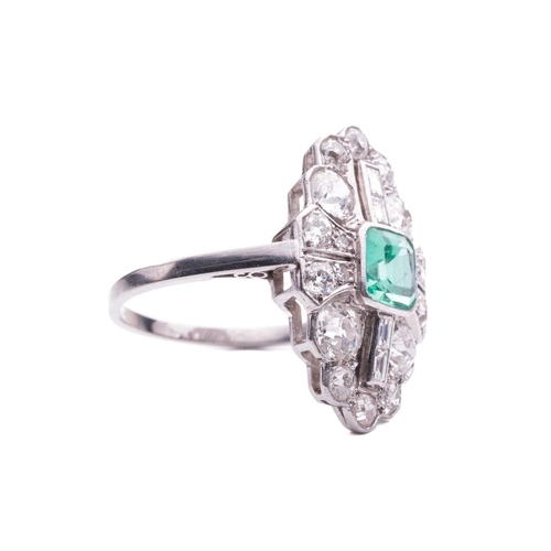 202 - An Art Deco emerald and diamond plaque ring, slightly raised at the centre with a square step-cut em... 