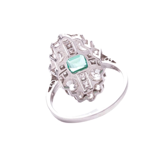 202 - An Art Deco emerald and diamond plaque ring, slightly raised at the centre with a square step-cut em... 