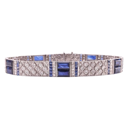 204 - An Art Deco sapphire and diamond line bracelet by Charles Holl, circa 1930, of highly flexible desig... 