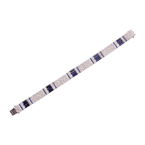 204 - An Art Deco sapphire and diamond line bracelet by Charles Holl, circa 1930, of highly flexible desig... 