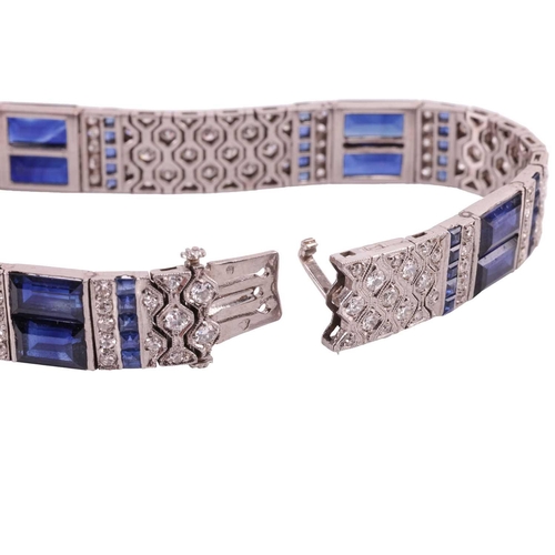 204 - An Art Deco sapphire and diamond line bracelet by Charles Holl, circa 1930, of highly flexible desig... 