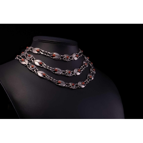 208 - Georg Jensen - a triple-strand floral necklace set with coral, comprising repoussé links in the form... 