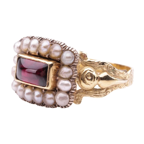 21 - A Victorian mourning ring set with garnet and split pearls, the scalloped rectangular panel centred ... 