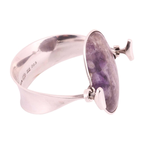 212 - Georg Jensen - 'Arm Ring' with amethyst, a tension clamp opening bangle with an oval panel of an opa... 