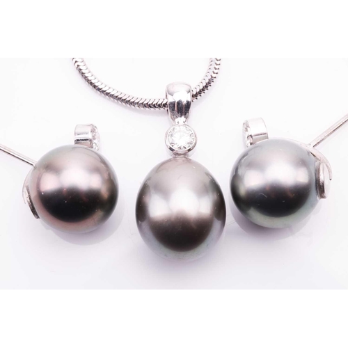 23 - A cultured Tahitian pearl and diamond pendant and earrings en-suite; the pendant on chain features a... 