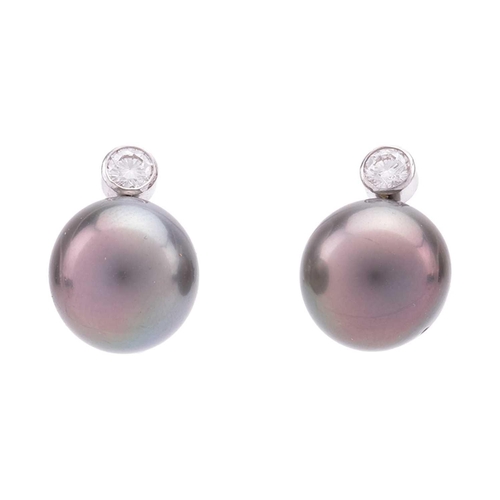 23 - A cultured Tahitian pearl and diamond pendant and earrings en-suite; the pendant on chain features a... 