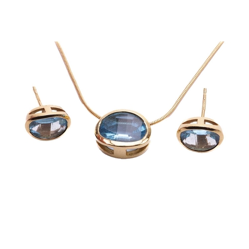 26 - A Swiss blue topaz pendant and earring suite, each oval gemstone bezel-set in yellow mounts tested a... 