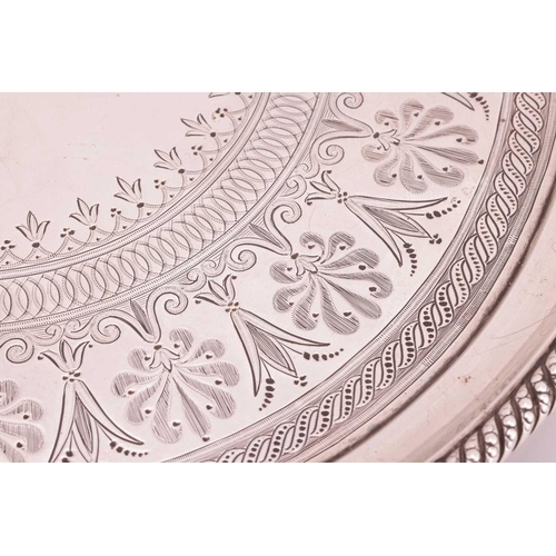 260 - A Victorian silver salver; circular with raised rope twist borders and scroll and foliate decorated ... 