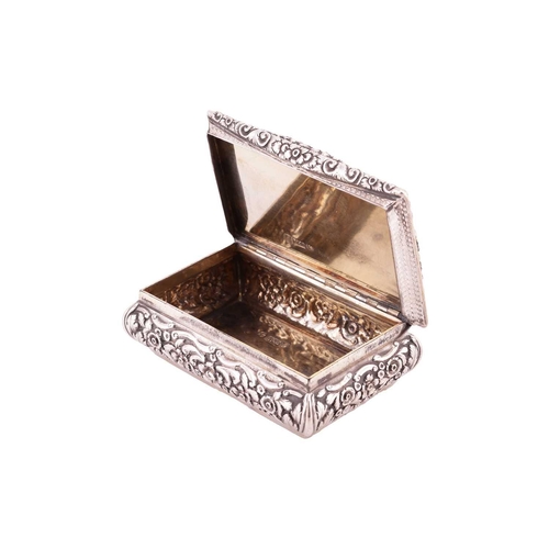 286 - A Victorian silver snuff box; rectangular, with applied cast foliate border, curved chased sides, an... 