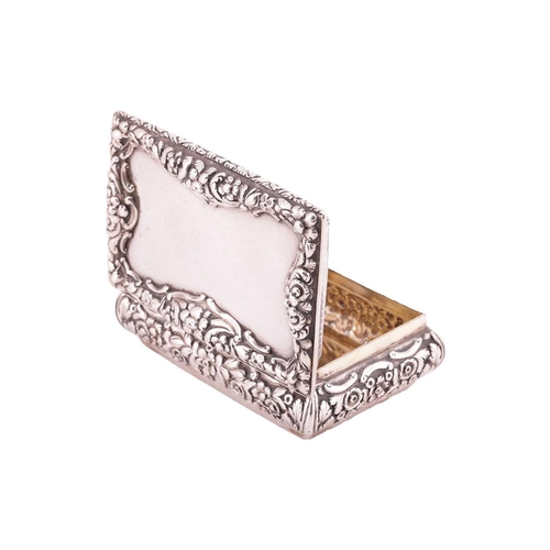 286 - A Victorian silver snuff box; rectangular, with applied cast foliate border, curved chased sides, an... 