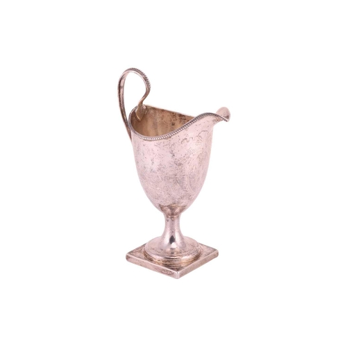 295 - A George III Newcastle silver helmet cream jug; with beaded borders and scroll handle; foliate swag ... 