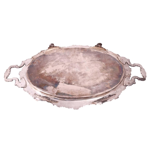 296 - An Edwardian silver two handled tray, oval with cast foliate border and shell mounted foliate side h... 