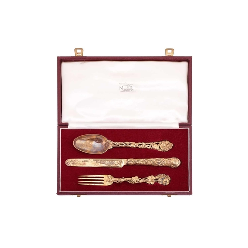 299 - A Victorian silver gilt three-piece Christening set; the cast terminals decorated with intertwined f... 