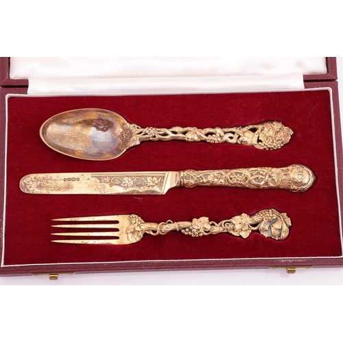 299 - A Victorian silver gilt three-piece Christening set; the cast terminals decorated with intertwined f... 