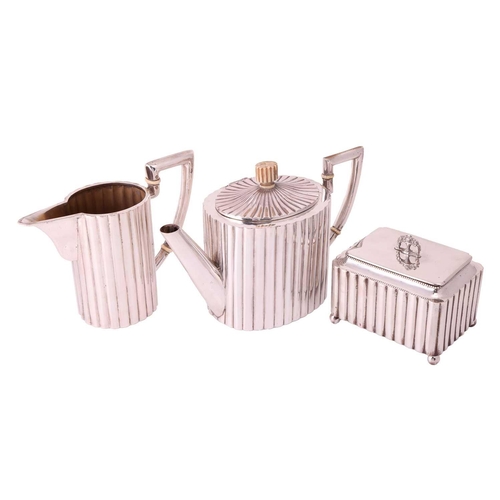 319 - An Art Deco three-piece tea service, comprising a tea pot of oval form with reeded body, the hinged ... 