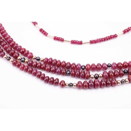 36 - Two ruby beaded necklaces with 18ct gold clasps; the first containing three strands of ruby beads wi... 