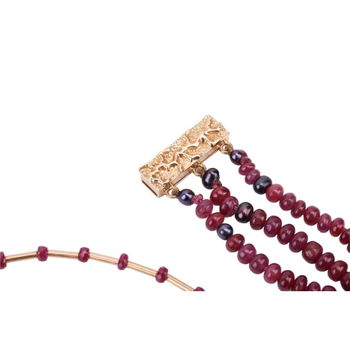 36 - Two ruby beaded necklaces with 18ct gold clasps; the first containing three strands of ruby beads wi... 