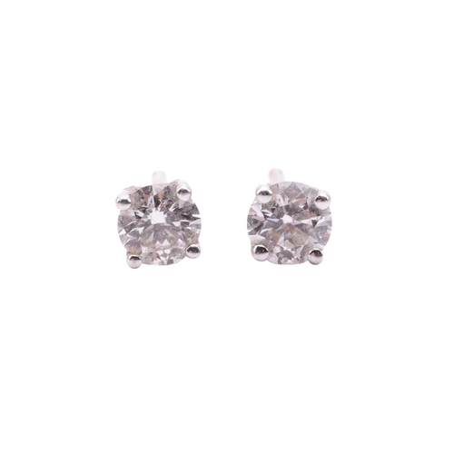 42 - A pair of diamond stud earrings with diamond-set enhancer halos, each central round brilliant diamon... 