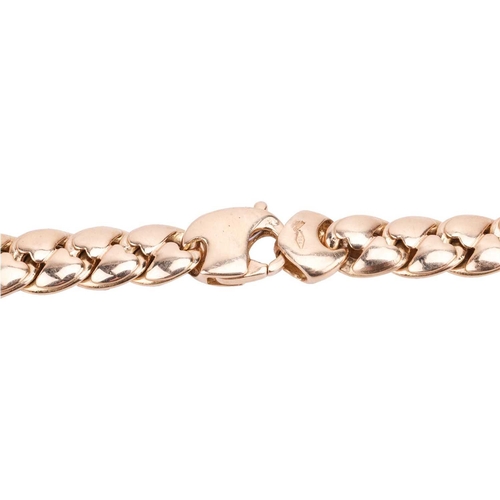 51 - A fancy curb link necklace in 18ct bi-coloured gold, alternating with gold and white gold links with... 