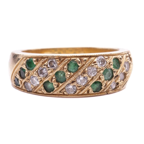 56 - An emerald and diamond-set ring, featuring alternating rows of diamonds and emeralds, grain set in a... 