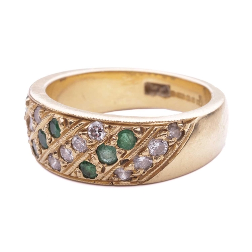 56 - An emerald and diamond-set ring, featuring alternating rows of diamonds and emeralds, grain set in a... 