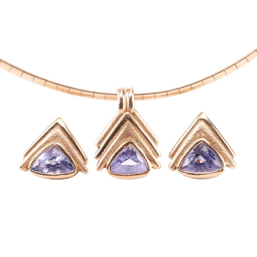 57 - A tanzanite pendant and earrings suite, featuring trillion-cut tanzanites set in chevron-style yello... 