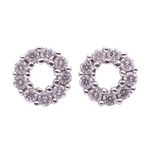 61 - A pair of diamond set circular stud earrings. The round brilliant cut diamonds weigh 0.39cts in tota... 