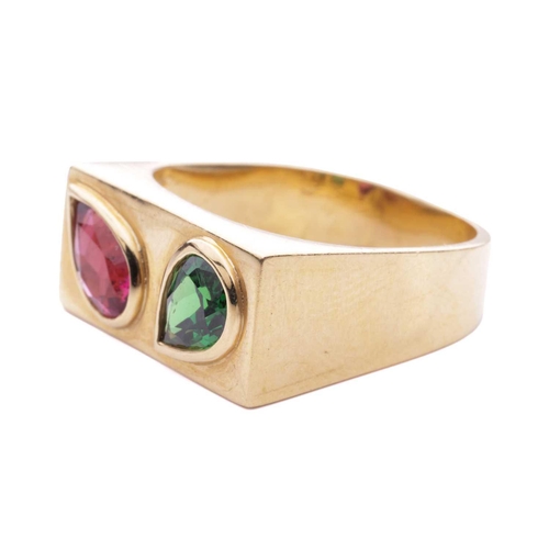 63 - A gem-set ring, featuring a pear-shaped rubellite and tsavorite, each bezel-set obliquely in an angl... 