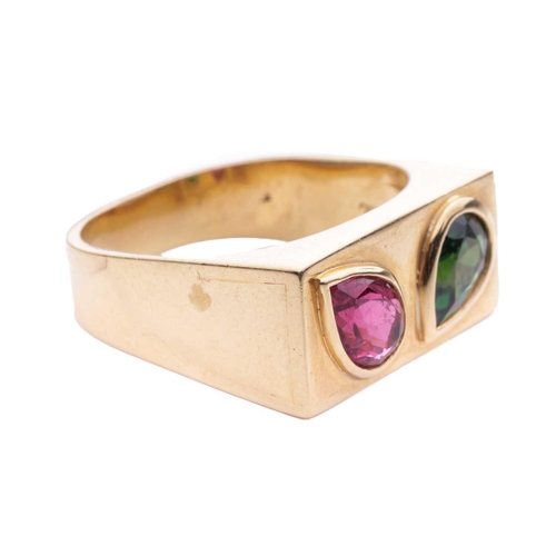 63 - A gem-set ring, featuring a pear-shaped rubellite and tsavorite, each bezel-set obliquely in an angl... 