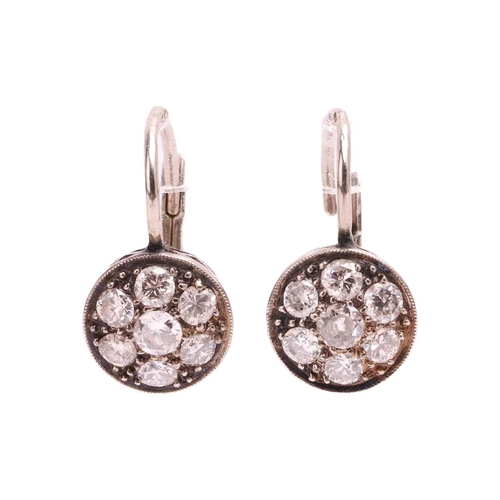 64 - A pair of diamond cluster earrings, each set with a cluster of old cut diamonds, the pair with a tot... 