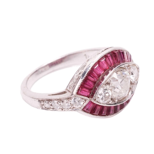 65 - An Art Deco style diamond and ruby-set navette ring, featuring three centrally-set old-cut diamonds,... 